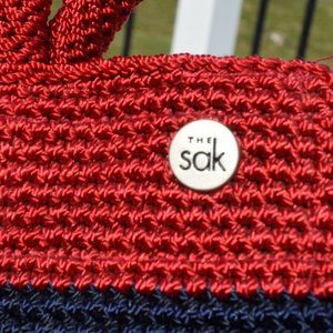 The Sak dark red crocheted handbag with blue and white horizontal stripe